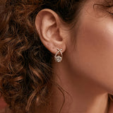 Oorbellen met gouden kruis en zirconia